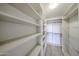 Walk-in closet with adjustable shelving and hanging rods for ample storage at 14250 W Wigwam Blvd # 2822, Litchfield Park, AZ 85340