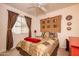 Guest bedroom with a double bed and unique decor at 16019 W Kino Dr, Surprise, AZ 85374