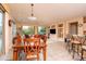 Dining area with a wood table and chairs, open to the living room at 16019 W Kino Dr, Surprise, AZ 85374