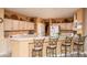 Spacious kitchen with light wood cabinets and a breakfast bar at 16019 W Kino Dr, Surprise, AZ 85374