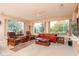 Relaxing living room with a red sofa and large windows at 16019 W Kino Dr, Surprise, AZ 85374