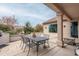 Outdoor patio dining area with table, chairs, and adjacent house at 16019 W Kino Dr, Surprise, AZ 85374