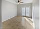 Well-lit bedroom with double doors leading to the outside at 16187 W Port Royale Ln, Surprise, AZ 85379