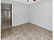 Spacious bedroom with tile flooring and access to hallway at 16187 W Port Royale Ln, Surprise, AZ 85379