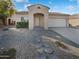 One-story house with a two-car garage and stone pathway at 16187 W Port Royale Ln, Surprise, AZ 85379