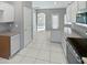 Modern kitchen with granite countertops, white cabinets, and a breakfast bar at 16187 W Port Royale Ln, Surprise, AZ 85379