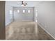 Large living room with tile flooring and ceiling fan at 16187 W Port Royale Ln, Surprise, AZ 85379