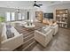 Spacious living room with comfortable seating and built-in shelves at 16187 W Port Royale Ln, Surprise, AZ 85379