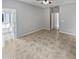 Spacious Primary bedroom with tile flooring and access to bathroom at 16187 W Port Royale Ln, Surprise, AZ 85379