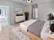 Bright bedroom with ensuite bathroom and wood dresser at 16187 W Port Royale Ln, Surprise, AZ 85379