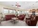 Living room with red couches and kitchen partially visible at 17906 W Agave Rd, Goodyear, AZ 85338