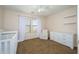 Comfortable bedroom with a crib, a white armchair, and lots of natural light at 17965 W Carol Ave, Waddell, AZ 85355