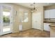 Bright dining area features tile floors, modern light fixture, and access to the backyard at 17965 W Carol Ave, Waddell, AZ 85355