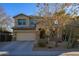 Two story home featuring a desert landscape, and a two car garage at 17965 W Carol Ave, Waddell, AZ 85355