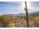 Stunning desert landscape with a large cactus in the foreground and mountains in the distance at 17965 W Carol Ave, Waddell, AZ 85355