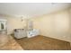 Bright, open-concept living area features tile flooring, neutral paint, and lots of natural light at 17965 W Carol Ave, Waddell, AZ 85355