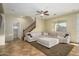 Comfortable living area with a large sectional, ceiling fan, and stairway access at 17965 W Carol Ave, Waddell, AZ 85355