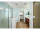Bright main bathroom featuring a glass shower, tub, and separate toilet, and walk in closet at 17965 W Carol Ave, Waddell, AZ 85355