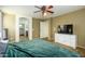 The main bedroom offers a large window, a ceiling fan, and a view to the ensuite bathroom at 17965 W Carol Ave, Waddell, AZ 85355