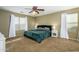 Spacious main bedroom boasts a ceiling fan, two windows, and neutral-colored carpet at 17965 W Carol Ave, Waddell, AZ 85355