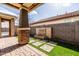 Tranquil backyard showcasing a custom stone water feature and lush landscaping at 18716 N Jameson Dr, Maricopa, AZ 85138