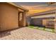 Beautiful backyard patio with stone pavers, a water feature, and lush landscaping at 18716 N Jameson Dr, Maricopa, AZ 85138