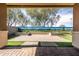 Covered backyard patio features a mural wall and hardscaped seating area at 18716 N Jameson Dr, Maricopa, AZ 85138
