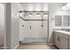 A glass enclosed shower featuring tile accents and dual shower heads, beside a dual sink vanity at 18716 N Jameson Dr, Maricopa, AZ 85138