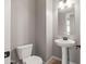 Bathroom features a pedestal sink, a toilet, and a mirror at 18716 N Jameson Dr, Maricopa, AZ 85138