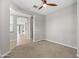 An empty bedroom featuring neutral walls, plush carpet, and a ceiling fan provides modern comfort at 18716 N Jameson Dr, Maricopa, AZ 85138