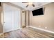 Bedroom featuring wood floors, a closet, and a mounted television at 18716 N Jameson Dr, Maricopa, AZ 85138