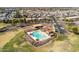 Aerial view of a well-kept community pool surrounded by lush green space and homes in a Gathering-friendly neighborhood at 18716 N Jameson Dr, Maricopa, AZ 85138