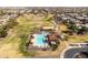 Aerial view of a pristine community pool and recreation area nestled within a vibrant residential neighborhood at 18716 N Jameson Dr, Maricopa, AZ 85138