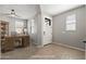 A staged entryway featuring a wooden desk and a bright white front door with glass panes at 18716 N Jameson Dr, Maricopa, AZ 85138