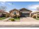 Charming single-story home featuring a well-manicured front yard and a two-car garage at 18716 N Jameson Dr, Maricopa, AZ 85138
