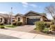 Inviting single-story home with a paved driveway and a beautifully landscaped yard at 18716 N Jameson Dr, Maricopa, AZ 85138