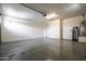 Bright garage boasts epoxy floors, water heater, door to outside, and garage door opener at 18716 N Jameson Dr, Maricopa, AZ 85138