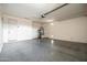 Large garage with epoxy floors, utility sink, door to outside, and water heater at 18716 N Jameson Dr, Maricopa, AZ 85138