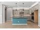 A modern kitchen featuring grey cabinets, a turquoise island, and stylish backsplash tile at 18716 N Jameson Dr, Maricopa, AZ 85138