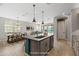 A staged kitchen with a large island, pendant lights, and a pantry provides ample storage and style at 18716 N Jameson Dr, Maricopa, AZ 85138