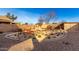 Landscaped backyard with desert plants, stone pathway, and storage shed at 18907 N Vemto St, Maricopa, AZ 85138