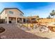 Two story home with covered patio, and a landscaped backyard with desert plants at 18907 N Vemto St, Maricopa, AZ 85138