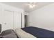 Bedroom with ceiling fan and navy blue bedding at 18907 N Vemto St, Maricopa, AZ 85138