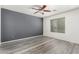 Bedroom with dark accent wall and wood-look floors at 18907 N Vemto St, Maricopa, AZ 85138