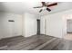 Bright bedroom with wood-look floors and ceiling fan at 18907 N Vemto St, Maricopa, AZ 85138