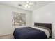 Bedroom with ceiling fan and navy blue bedding at 18907 N Vemto St, Maricopa, AZ 85138