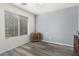 Bright bedroom with wood-look floors and window blinds at 18907 N Vemto St, Maricopa, AZ 85138