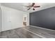 Bedroom with dark accent wall and wood-look floors at 18907 N Vemto St, Maricopa, AZ 85138