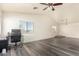 Spacious bedroom with wood-look floors, ceiling fan, and office area at 18907 N Vemto St, Maricopa, AZ 85138