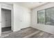 Spacious bedroom featuring wood-look floors and double doors at 18907 N Vemto St, Maricopa, AZ 85138